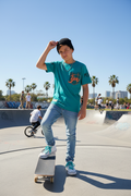 14-year-old at skate park wearing turquoise t-shirt
