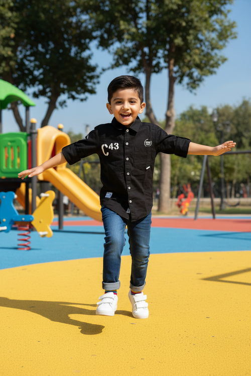 Boy in black C43 shirt with navy blue jeans
