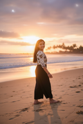 Girl wearing butterfly print co-ord - beach setting