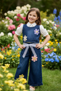 Girl wearing denim flower co-ord with belt tied - garden setting