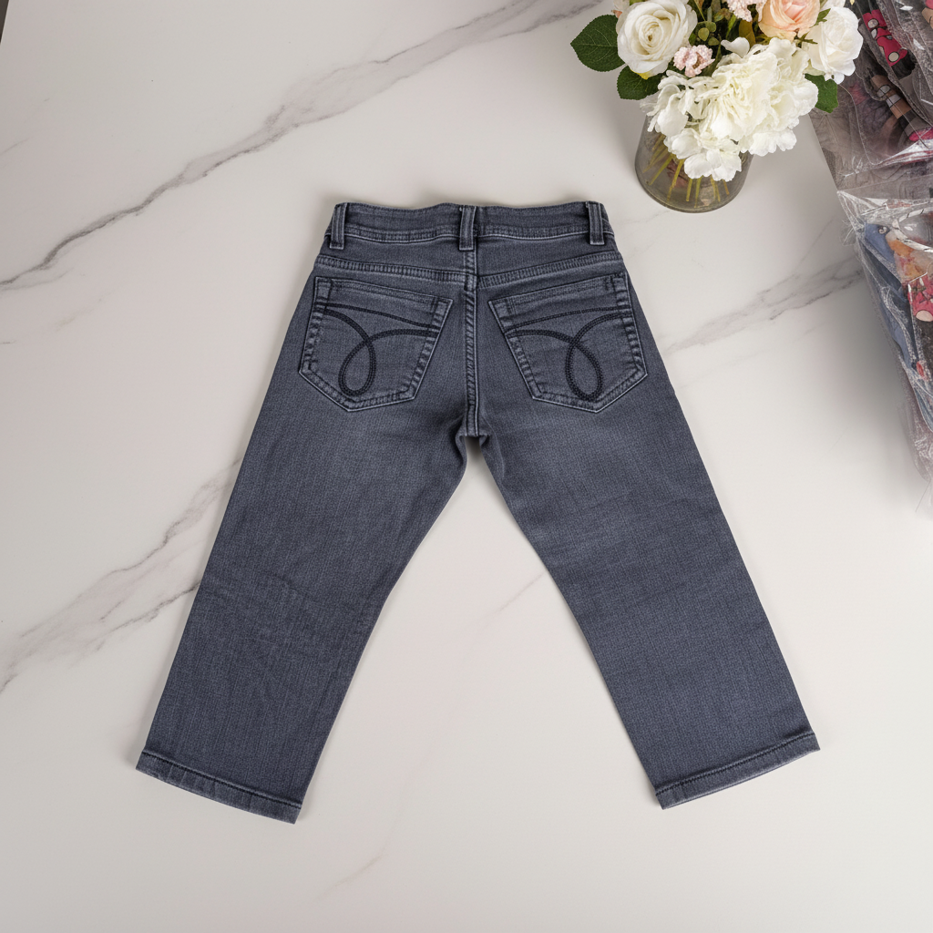 Grey denim jeans back view - marble surface