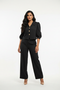 Indian model wearing black puff sleeve blazer and wide-leg trouser set