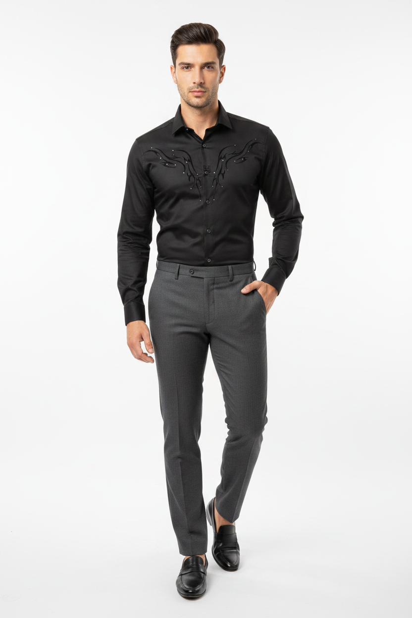 Male model wearing black abstract pattern shirt tucked into dark trousers
