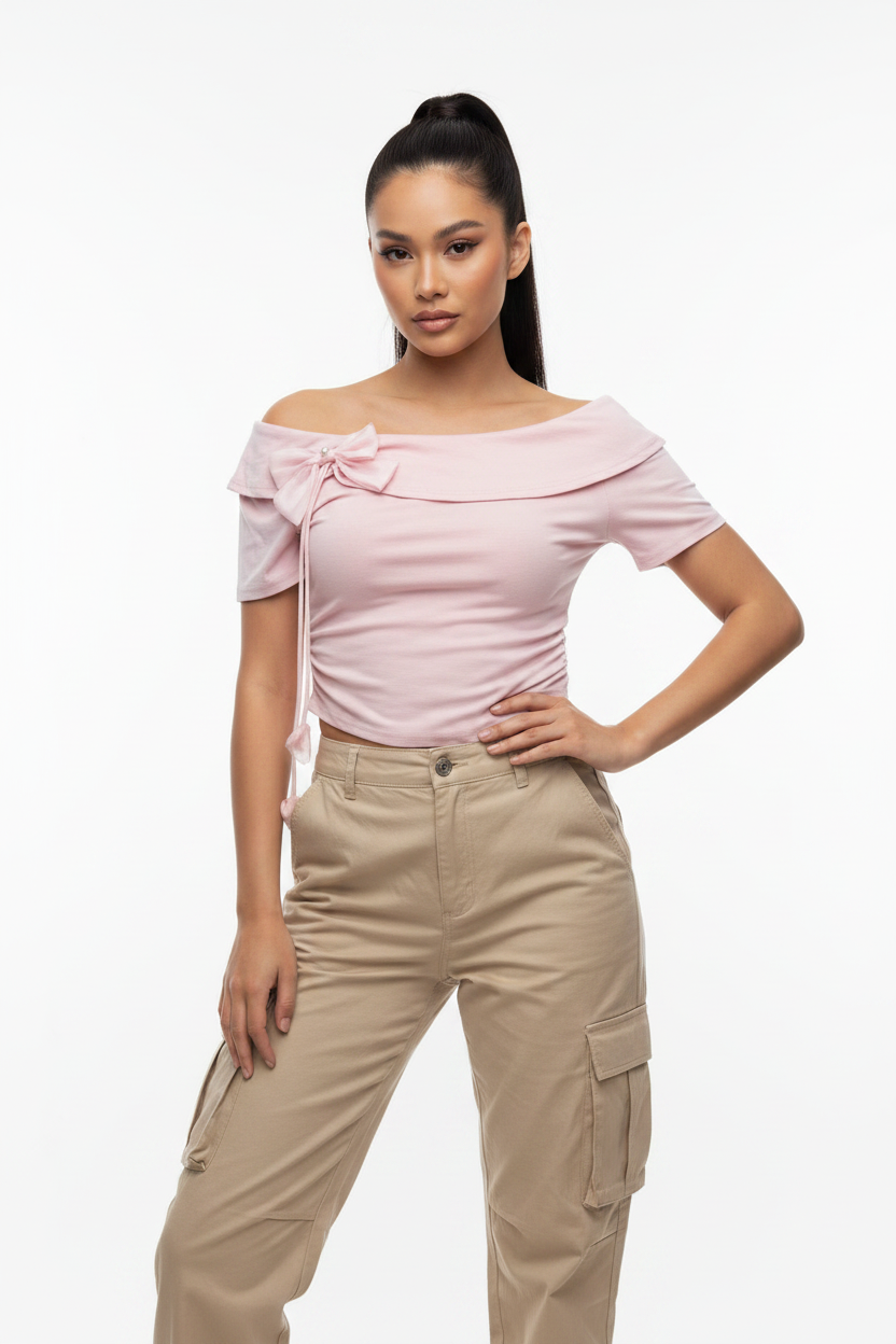Model wearing Off-Shoulder Bow Crop Top in Pink