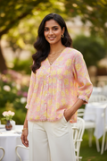 Model wearing Floral Pintuck Blouse in Pink Yellow – mixed culture