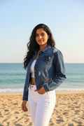 Indian model wearing distressed cropped denim jacket - three quarter view