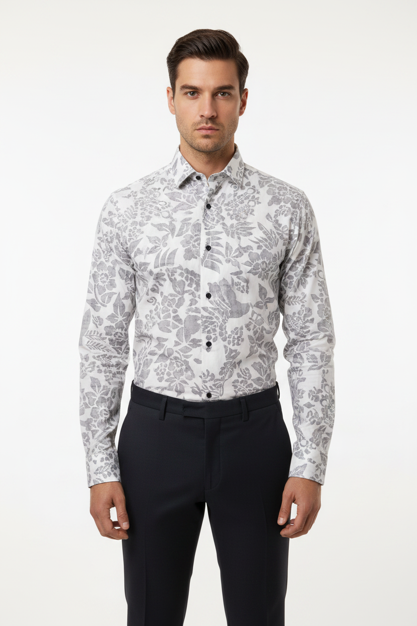 Male model wearing grey floral print shirt tucked in with dark trousers – front view