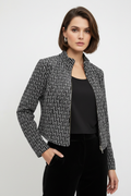 Model wearing black and white geometric velvet jacket and sleeveless top two-piece set