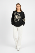 Kiwi model wearing Floral Embroidered Knit Sweater in Black – studio